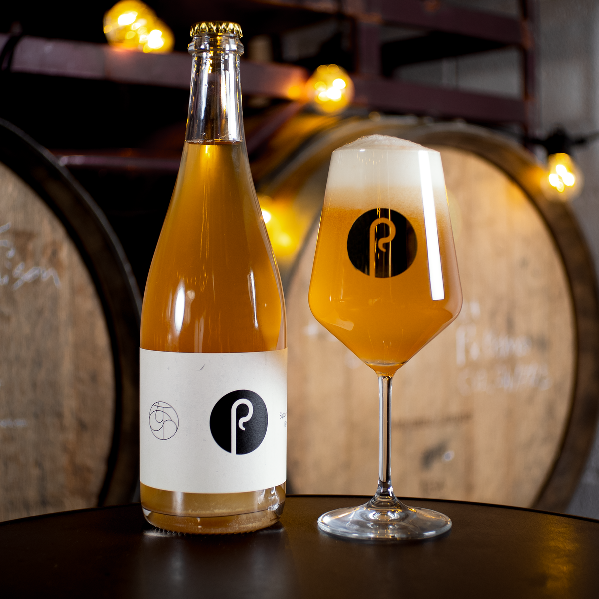 Two freshly poured Pastore sour beers beside Crumble and Pavlova cans